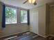 Bedroom with two windows allowing natural light, ceiling fan, and closet at 365 Fletcher Ave, Daytona Beach, FL 32114