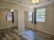 Bright bedroom with ceiling fan, wood laminate floors, and large closets with mirrored doors at 365 Fletcher Ave, Daytona Beach, FL 32114