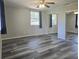 Spacious bedroom with wood laminate floors, two windows, and large closet at 365 Fletcher Ave, Daytona Beach, FL 32114