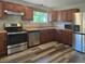 Modern kitchen featuring stainless steel appliances, wood cabinets, and stylish flooring at 365 Fletcher Ave, Daytona Beach, FL 32114