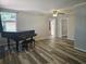 Bright living room featuring wood-look floors and a black grand piano at 365 Fletcher Ave, Daytona Beach, FL 32114