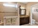 Well-lit bathroom with a glass-enclosed shower, granite countertop, and tile flooring at 3809 Arlington Ridge Blvd, Leesburg, FL 34748