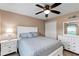 Cozy bedroom with a queen-size bed, white furniture set, and a ceiling fan for added comfort at 3809 Arlington Ridge Blvd, Leesburg, FL 34748