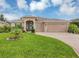 Spacious single-story home featuring a manicured lawn, three-car garage, and neutral stucco exterior at 3809 Arlington Ridge Blvd, Leesburg, FL 34748