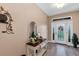 Welcoming foyer with stylish decor, a decorative mirror, and a view of the front door at 3809 Arlington Ridge Blvd, Leesburg, FL 34748