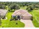 Beautiful single-story home on a lush lot featuring a three-car garage and well-manicured landscaping at 3809 Arlington Ridge Blvd, Leesburg, FL 34748