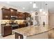 Lovely kitchen with granite countertops, stainless steel appliances, and brown cabinetry at 3809 Arlington Ridge Blvd, Leesburg, FL 34748