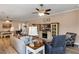 Spacious living room with stylish furniture, a ceiling fan, and an adjacent dining area at 3809 Arlington Ridge Blvd, Leesburg, FL 34748