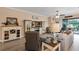 Cozy living room featuring modern decor, comfortable seating, and sliding glass doors to the outdoors at 3809 Arlington Ridge Blvd, Leesburg, FL 34748