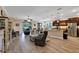 Spacious living room featuring hardwood floors, a view of the backyard, and a cozy seating area at 3809 Arlington Ridge Blvd, Leesburg, FL 34748