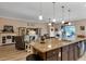 Open-concept living room with stone countertops, modern decor, and access to outdoor space at 3809 Arlington Ridge Blvd, Leesburg, FL 34748