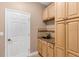 Functional mud room with storage cabinets, a sink, and a doorway, providing a practical transition space at 3809 Arlington Ridge Blvd, Leesburg, FL 34748