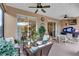 Covered patio with comfortable seating, ceiling fans, and sliding glass doors to allow natural light at 3809 Arlington Ridge Blvd, Leesburg, FL 34748