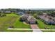 Aerial view of home featuring mature landscaping, a brick driveway, and an attached two-car garage at 39504 Hillrise Ln, Lady Lake, FL 32159