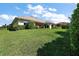 Spacious backyard view, showcasing well-kept lawn and mature landscaping enhancing privacy and curb appeal at 39504 Hillrise Ln, Lady Lake, FL 32159