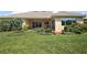 Spacious backyard with lush green lawn and a view of the covered patio at 39504 Hillrise Ln, Lady Lake, FL 32159