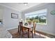 Cozy dining area filled with natural light from a large window overlooking the landscaped yard at 39504 Hillrise Ln, Lady Lake, FL 32159