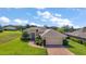 Charming home showcasing a well-manicured front yard, brick driveway, attached garage, and beautiful curb appeal at 39504 Hillrise Ln, Lady Lake, FL 32159