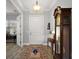Bright foyer featuring hardwood floors, a white front door, and a vintage grandfather clock at 39504 Hillrise Ln, Lady Lake, FL 32159