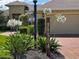 Charming home address sign with white flowers, leading to a well-maintained house at 39504 Hillrise Ln, Lady Lake, FL 32159