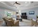 Bright living room with sliding glass doors and modern ceiling fan at 39504 Hillrise Ln, Lady Lake, FL 32159