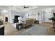 Open-concept living room with wood floors, a tray ceiling, and bright decor with a coastal flair at 39504 Hillrise Ln, Lady Lake, FL 32159