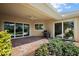 Covered patio with brick flooring, ceiling fan and sliding glass doors to the interior at 39504 Hillrise Ln, Lady Lake, FL 32159