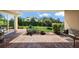 View of the patio overlooking the landscaped backyard with lush green lawn at 39504 Hillrise Ln, Lady Lake, FL 32159