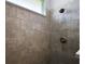 Tiled walk-in shower with a glass partition, offering a modern and spacious feel at 39504 Hillrise Ln, Lady Lake, FL 32159
