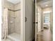 Bathroom featuring tile shower with rainfall shower head and a barn door adding modern elegance at 40140 Palm St, Lady Lake, FL 32159