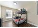 Bedroom featuring a bunk bed, and window with wood-look flooring creating a serene and restful atmosphere at 40140 Palm St, Lady Lake, FL 32159