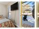 Bedroom with mounted TV and view to the screened-in pool at 40140 Palm St, Lady Lake, FL 32159
