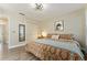 A cozy bedroom featuring a ceiling fan, closet, and comfortable patterned bedding at 40140 Palm St, Lady Lake, FL 32159