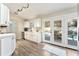 Bright kitchen leads to outdoor pool area through glass doors at 40140 Palm St, Lady Lake, FL 32159