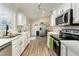 Stylish kitchen features stainless steel appliances and white cabinets for a modern look at 40140 Palm St, Lady Lake, FL 32159