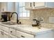 Close-up of a kitchen counter with marble countertops, stainless steel sink, and modern faucet at 40140 Palm St, Lady Lake, FL 32159