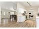 Bright kitchen with white cabinets, marble countertops, and open layout to the dining area at 40140 Palm St, Lady Lake, FL 32159