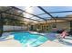 A dazzling screened-in pool area with ample seating and sunny views at 40140 Palm St, Lady Lake, FL 32159