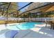 Backyard featuring a screened pool and lounging area offering a perfect setting for leisure and enjoyment at 40140 Palm St, Lady Lake, FL 32159