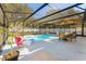 Relaxing screened-in pool area, perfect for outdoor dining and lounging on a sunny day at 40140 Palm St, Lady Lake, FL 32159