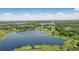 Stunning aerial view of a serene lake surrounded by lush greenery, showcasing a tranquil setting at 40143 Babb Rd, Umatilla, FL 32784
