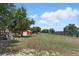 Backyard with a playground for and a spacious grass area and barn for outdoor activities at 40143 Babb Rd, Umatilla, FL 32784