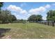 Sprawling backyard with lush green grass, and perimeter fencing, perfect for outdoor activities at 40143 Babb Rd, Umatilla, FL 32784