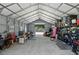 Expansive metal barn interior featuring high ceilings, storage racks, and abundant workspace at 40143 Babb Rd, Umatilla, FL 32784