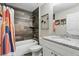 Bathroom featuring wood-look tile, granite vanity, and shower-tub combination at 40143 Babb Rd, Umatilla, FL 32784