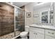 Bathroom features tiled shower, updated fixtures, granite countertop, and a bright mirror at 40143 Babb Rd, Umatilla, FL 32784