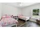 Bedroom with wood flooring featuring twin beds and a window providing natural light at 40143 Babb Rd, Umatilla, FL 32784