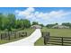 Scenic front exterior with long driveway, fenced yard and plenty of grass at 40143 Babb Rd, Umatilla, FL 32784