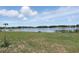 Scenic lakefront view with a small boat and lush green surroundings at 40143 Babb Rd, Umatilla, FL 32784