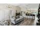 Spacious living room with wood floors, high ceilings, and open to bright kitchen at 40143 Babb Rd, Umatilla, FL 32784